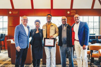  Joe Hooks smiles with his parents, Detroit Golf Club President  Keith Hazely and Rocket Mortgage Classic Tournament Director Mark Hollis after receiving his exemption. 