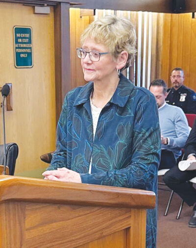  Grosse Pointe Farms Municipal Court Clerk Donna Emery Rabaut — who is being promoted to court administrator in April — listens as Mayor John Gillooly discusses her wide-ranging abilities during a March 9 City Council meeting. 