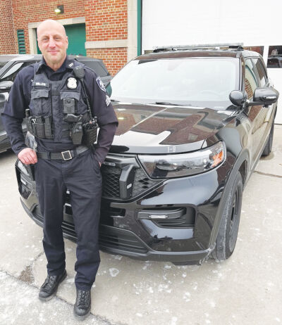  Grosse Pointe Park Public Safety Sgt. Mike Miller — standing in front of one of the department’s  vehicles — recently retired after nearly three decades of service. 