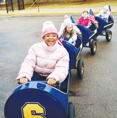  Shrine Grade School students enjoy the train ride behind the golf cart. 