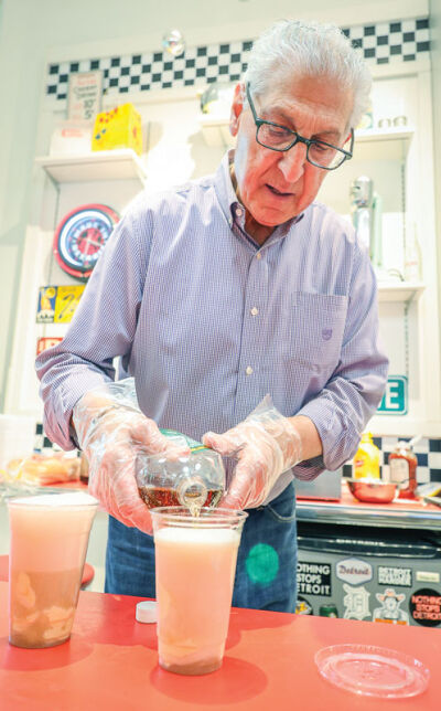  Mickey Mardirosian pours Vernors ginger ale to make floats during the event. 