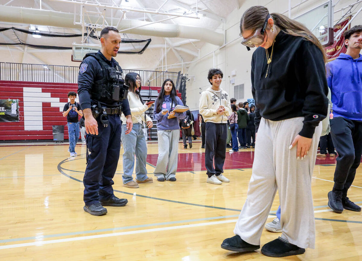  Warren Police Department officers had students walk the line during a simulated road sobriety test while wearing goggles that simulated being under the influence of alcohol.  