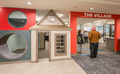 Many spots in the new Roseville Public Library are identified with signage, including the Village, a large space for children to enjoy books and other activities.  