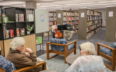  During the March 28 sneak peek, patrons in the adult gathering area listen to music performed by Delani Creech on cello and Zach Gutman on guitar.  