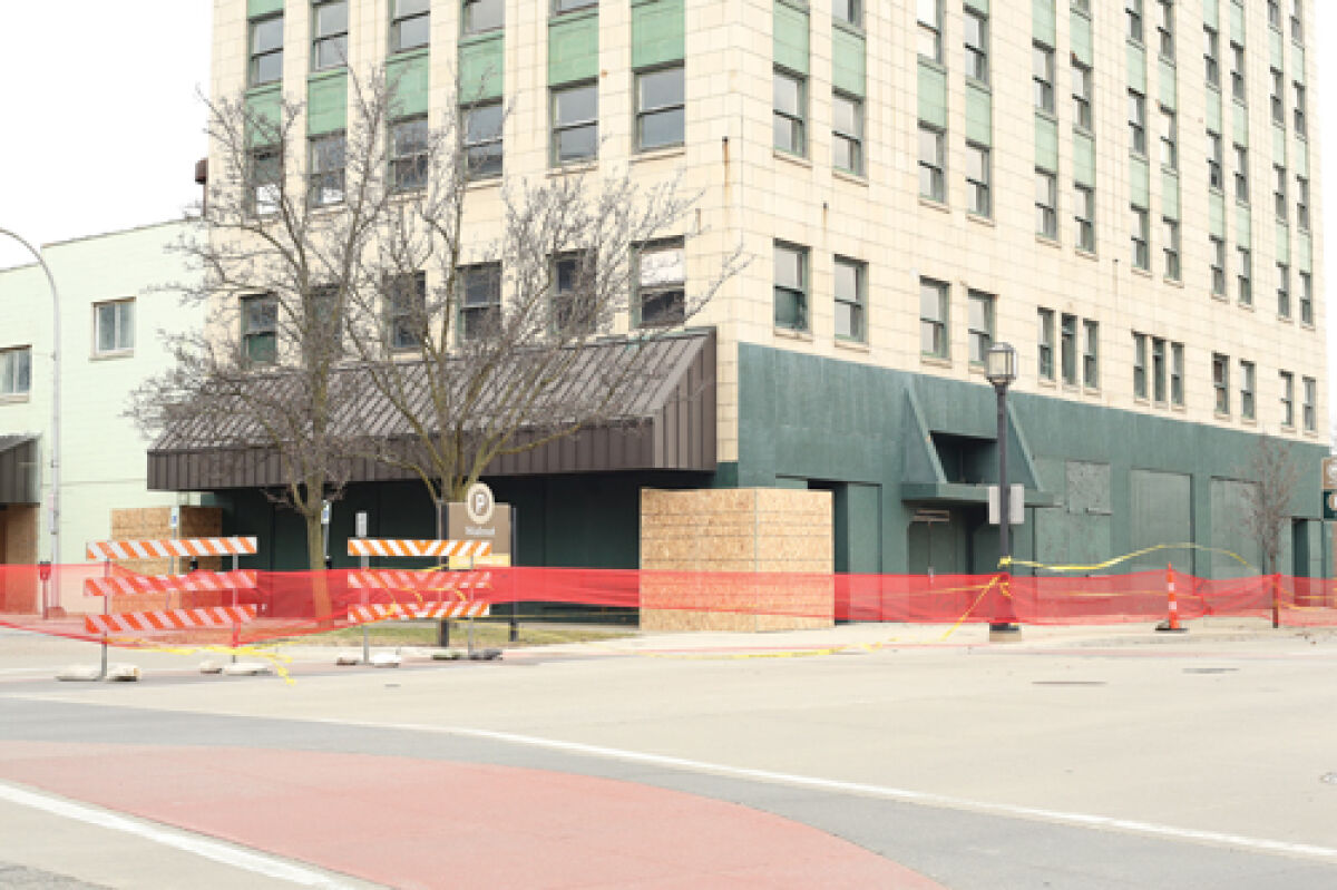  Barriers and temporary fencing prevent pedestrians from getting close to the Macomb Daily building, where falling facade pieces were reported on March 20.  