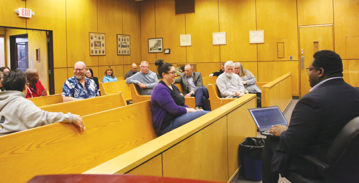  Attendees at the second Ad-Hoc Committee on Homelessness and Housing Instability meeting discuss experiences related to homelessness on March 25. Mount Clemens City Commissioner Spencer Calhoun, off to the right, moderates the meeting. 