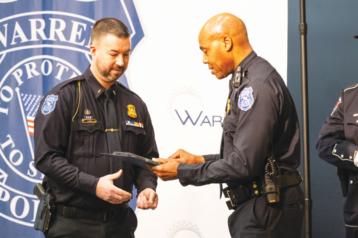  Warren Police Commissioner Eric Hawkins, right, presents  Lt. Brandon Roy with the Command Officer of the Year award at the inaugural Commissioner’s Award Ceremony March 27. 