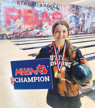  Ava Mazza poses with a Michigan High School Athletic Association State Champion sign after winning the 2026 individual state title at Thunderbowl Lanes in Allen Park March 2. 