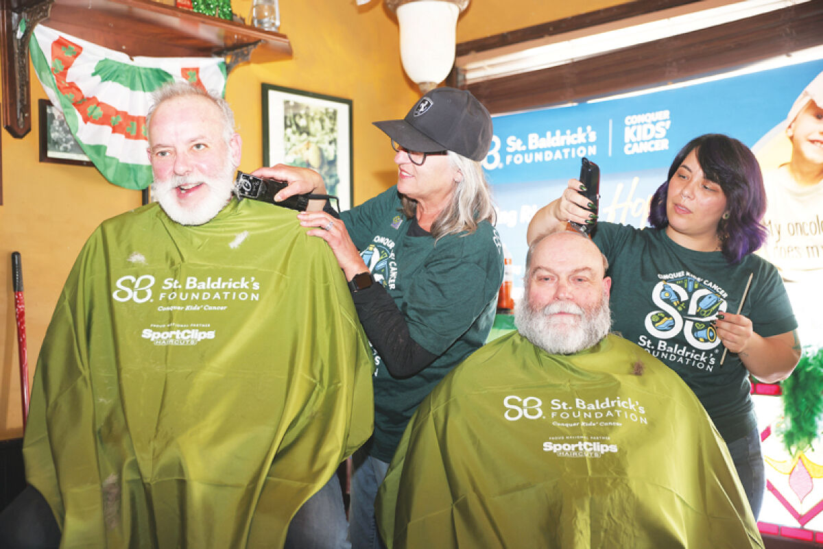  Utica Mayor Gus Calandrino and Shelby Township businessman James Gavlinski get their heads and beards shaved at the St. Baldrick’s Foundation fundraiser at O’Connor’s Public House March 29. 
