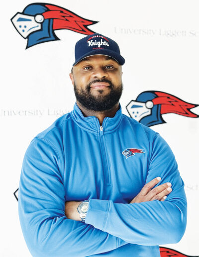  Vincent C. Phillips Jr. poses for a picture in front of a University Liggett School backdrop after being named the program’s new head football coach. 
