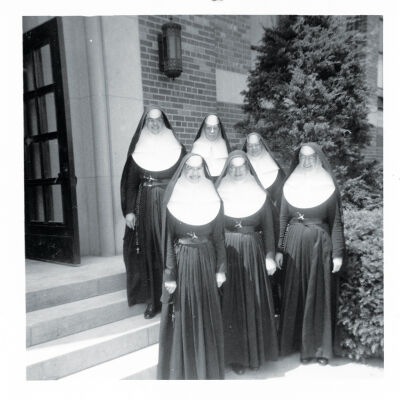  A group of nuns stand outside Our Lady  of La Salette School. 