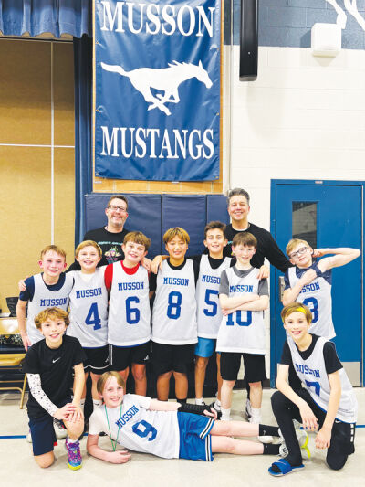  Kerry Dillard (back left) and Matt Hunnitcutt (back right) pose with the Musson Mustang basketball fifth-grade basketball team. 