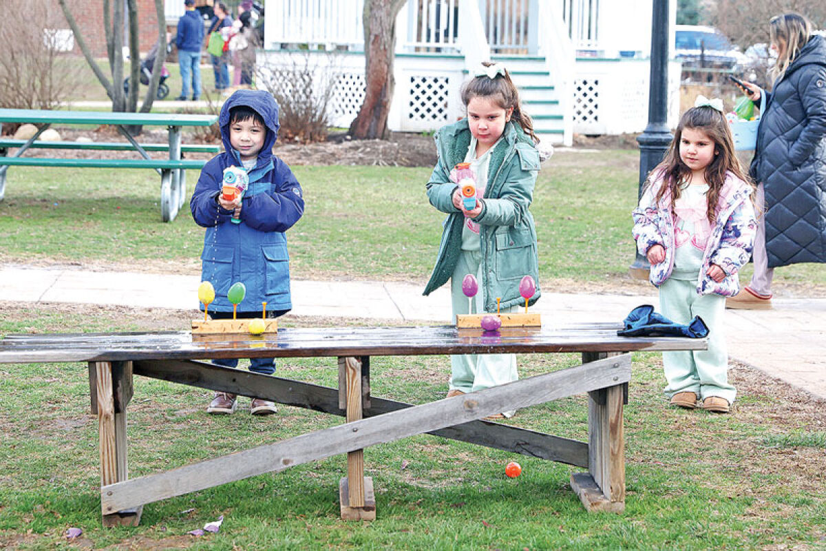  Troy Historic Village’s Spring Egg Hunt, held March 27-28, was about more than just finding hidden eggs and redeeming them for prizes. Here, attendees play a game where they use squirt guns to knock over targets. 