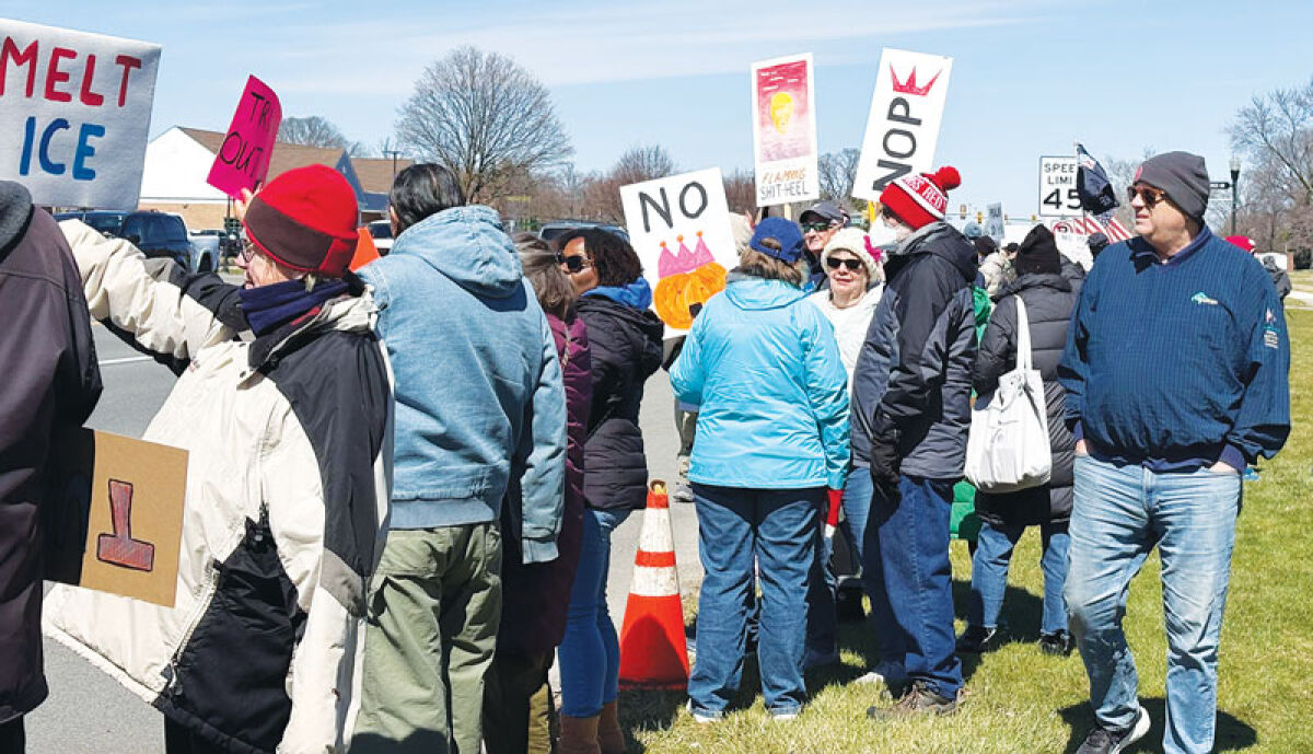 Protesters line up at the roadway in front of Lathrup Village City Hall for the No Kings Protests on March 28. 