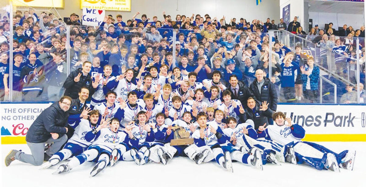  Detroit Catholic Central players and coaches hold up seven fingers after winning the program’s seventh consecutive state title March 7 at USA Hockey Arena in Plymouth. 