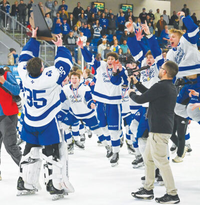  Detroit Catholic Central players skate to the Michigan High School Athletic Association Division 1 State Championship trophy after Catholic Central’s 6-0 victory over Northville March 7. 