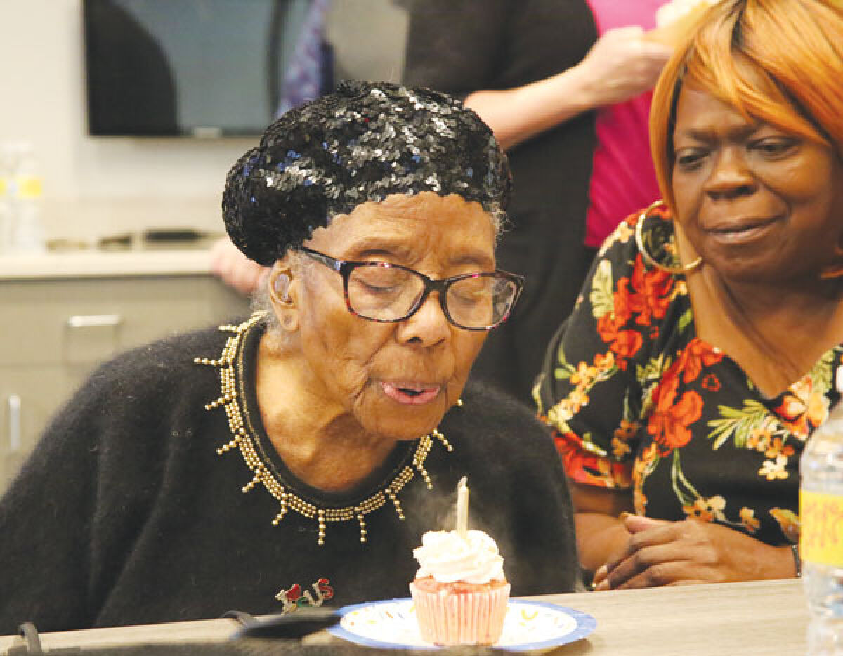  Grace Falconer, 100, blows out the candle on her cupcake at the Macomb County centenarian celebration on Oct. 25. Falconer spent her life traveling the world, visiting such places as Africa, Asia, Southern Europe and the Caribbean. 
