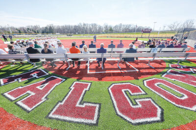  Players, coaches and staff sit on the new Henry Ford II High School softball field during a ceremony April 9. 