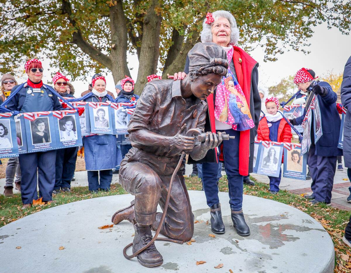  Known as “Rosie Fran,” Frances Mauro Masters, 103, of Chesterfield Township, poses with the Michigan World War II Legacy Memorial sculpture bearing her likeness during its dedication Nov. 11, 2025, as part of Phase 2 of the memorial in Royal Oak. On May 8, V-E Day, the Michigan World War II Legacy Memorial will dedicate the second part of the sculpture. 