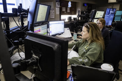  Warren Police dispatcher Linda DeVooght works a computer while answering calls in the department's dispatch center April 13.  