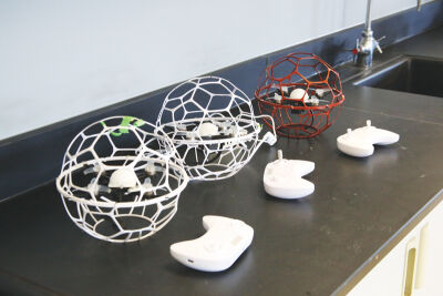  With video-game-like controllers  and protective cages, the drones used by the Youth Foundations in Flight program differ little  from quadcopter drones being used commercially today.  