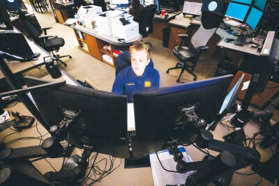  Austin Roman, Warren Police’s newest dispatcher, looks over screens while answering fire calls in the department’s dispatch center April 13.  