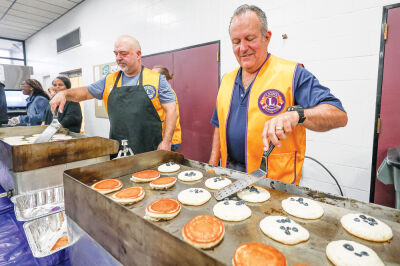  Center Line Lions Club Vice President John Hanselman, left, and Center Line Mayor Bob Binson, treasurer of the Lions Club, serve up stacks of pancakes April 12 at Center Line High School. 