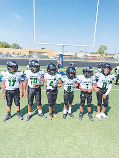  Warren Jets players stand side by side before a game in 2024. 