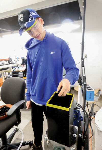  Warren Woods Tower High School  student Austin Korte, 18, works on the  granulator in class April 2. 