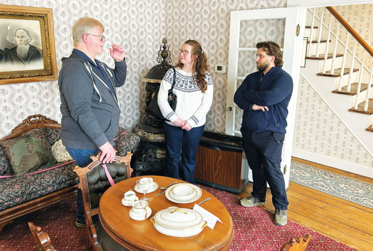  Fraser Historical Commission Vice Chair Tom Iwanicki, left, talks to Michelle and Jordan Ulbrich at the Baumgartner House Museum on April 12. 