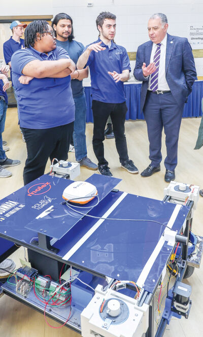  Mechanical lead engineer of the Intelligent Ground Vehicle Competition team Anthony Gabrail, of Sterling Heights, talks with LTU President Tarek M. Sobh about the competition vehicle named “Blue Box.”  