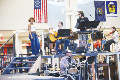  Alise Herron performs a song with a live band during a rehearsal on April 16 for the Berkley High School production of “Hadestown,” which the students will perform  April 23-25 at Bonstelle Playhouse in Detroit.  