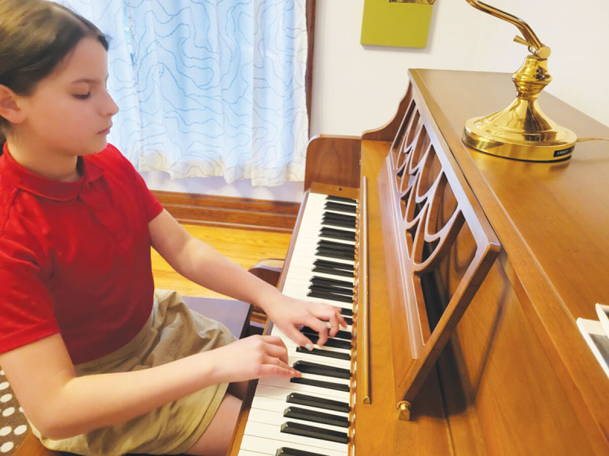  Nora C. Harris-Ko plays Bach on her piano at home. 