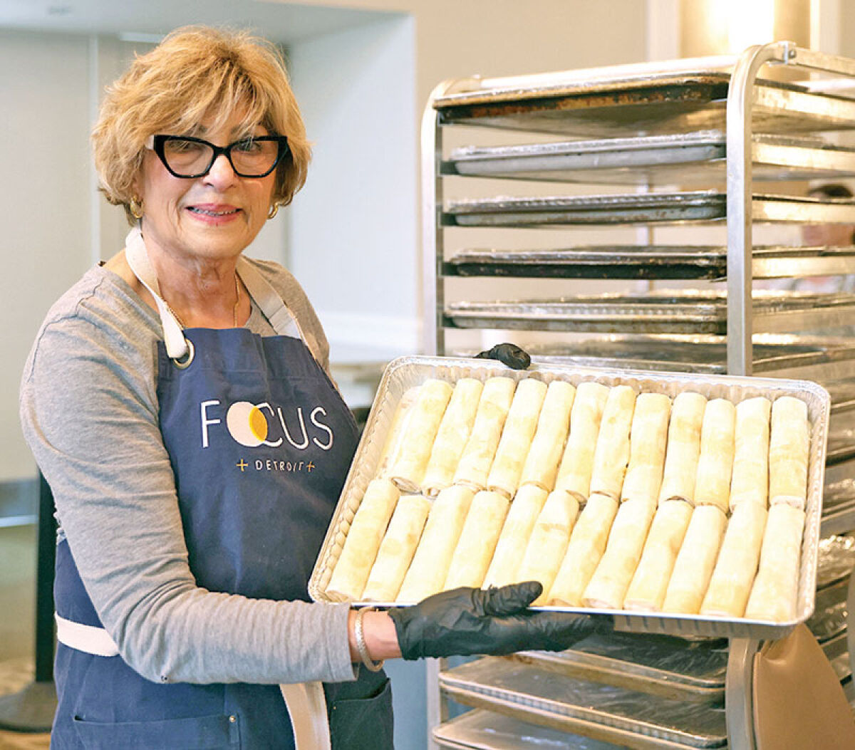  Val Badamo, of Berkley, shows off some freshly made Galaktoboureko. She was among the volunteers recently prepping pastries for Opa Fest at St. Nicholas Greek Orthodox Church, which will be held June 12-14. 