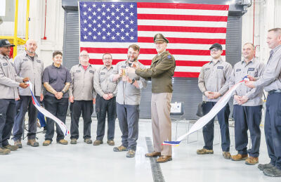  Facility workers celebrate the April 16 ribbon cutting of a new Area Maintenance Support Activity facility for the Army Reserve in Southfield on 11 Mile Road. 
