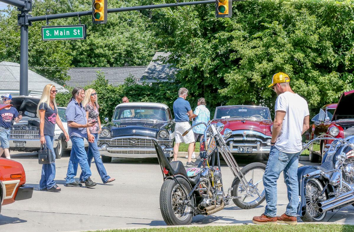  Attendees enjoy looking at the classic cars and motorcycles at the Down on Main Street charity car show in 2023. This year's show will take place Saturday, Aug. 8. 