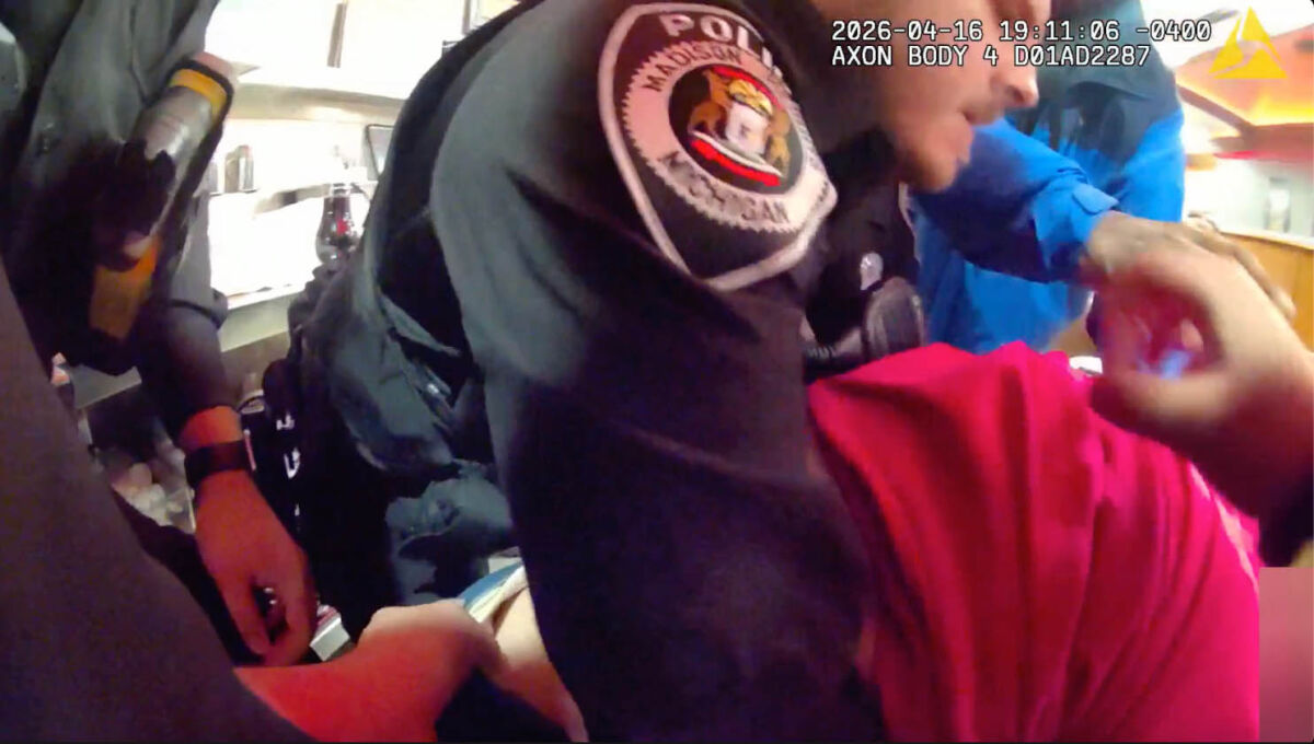  A group of Madison Heights police officers race against time to save a choking woman at Charlie’s Restaurant April 16, seen here in a screenshot from footage taken by an officer’s body camera. 