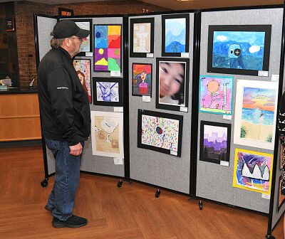  A man looks at the student artwork inside the lobby of the Royal Oak Public Library. 