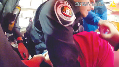  A group of Madison Heights police officers race against time to save a choking woman at Charlie’s Restaurant April 16, seen here in footage taken by an officer’s body camera. 
