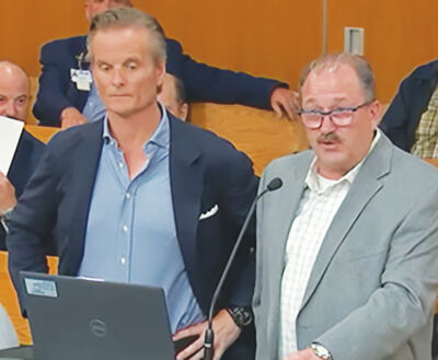  Michael French, Priority Waste chief strategy and growth officer, and Sam Caramagno, Priority Waste vice president of municipal relations, address the Clinton Township Board of Trustees on April 27 about  the company’s impending  ownership change. 