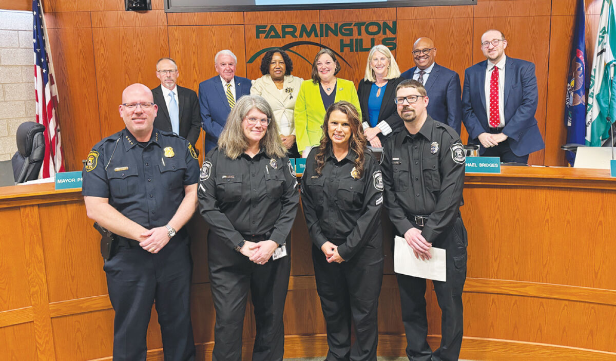  Joined by Farmington Hills City Council, rear, and Police Chief John Piggott, the dispatch team is honored during Nation Public Safety  Communicators Week. Pictured are Catherine Mason, lower row, second left, as well as Jennifer Robertson and Tony Stacer. 