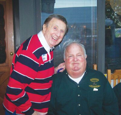  James Binson, who believed in giving back to the community, chats with television and radio personality Sonny Elliot and at a past Karmanos chili cook-off fundraiser. 