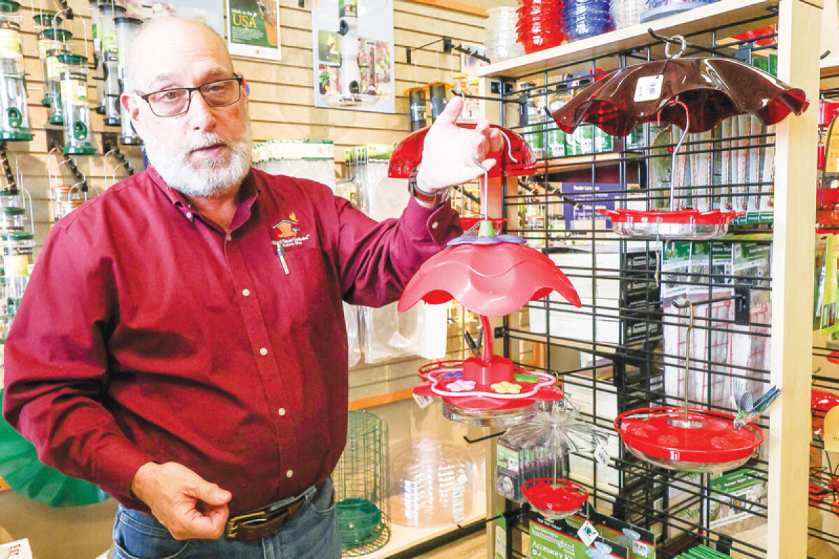  Bob Gors holds a hummingbird feeder sold at his Wild Birds Unlimited store in Macomb Township.  