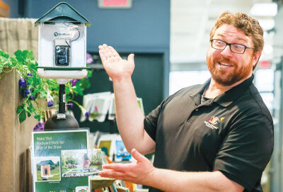  Wild Birds Unlimited in Grosse Pointe Woods co-owner Ryan Blagdurn shows a bird feeder camera.  The technology can film birds and identify them for its users.  