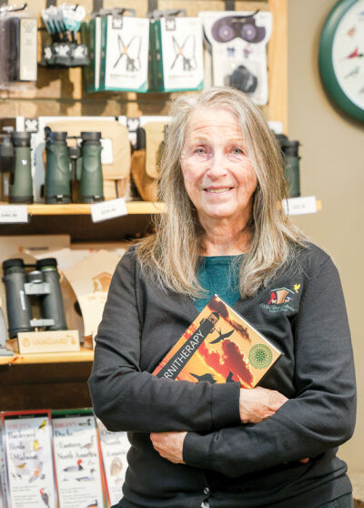  Wild Birds Unlimited in Grosse Pointe Woods co-owner Rosann Kovalcik holds a book written about ornitherapy, which uses nature and birds to calm the mind.  