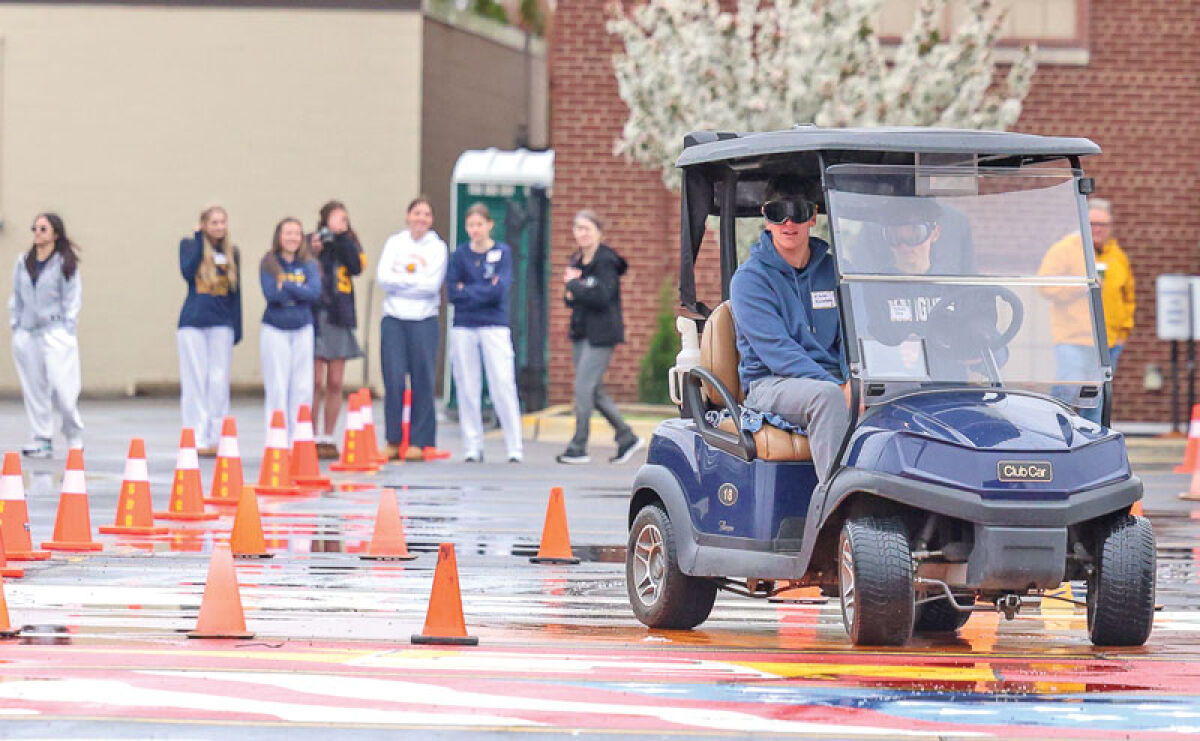 Shrine Catholic High School sophomores attempt to drive through an obstacle course while wearing goggles that simulate impairment from drinking April 29. 