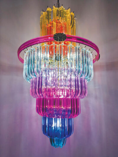  Ava Dark remakes light fixtures that she finds on Facebook Marketplace, such as this colorful piece hanging from a ceiling. 