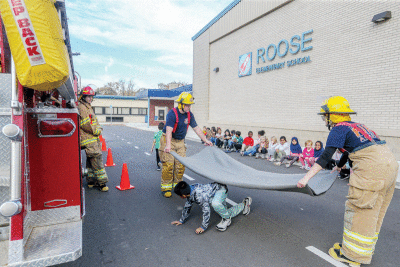   The Roose students participate in the blanket game Oct. 25. The blanket represents smoke, and students learned to crawl to get away  from the smoke. 