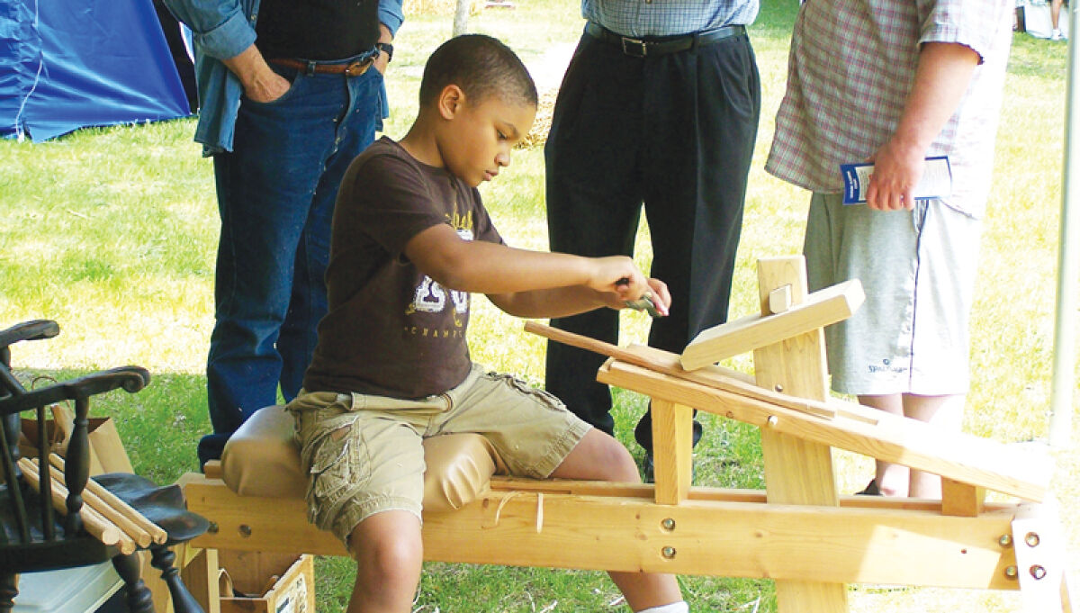  A child tries out an activity during a past Greater Rochester Heritage Days Festival.  