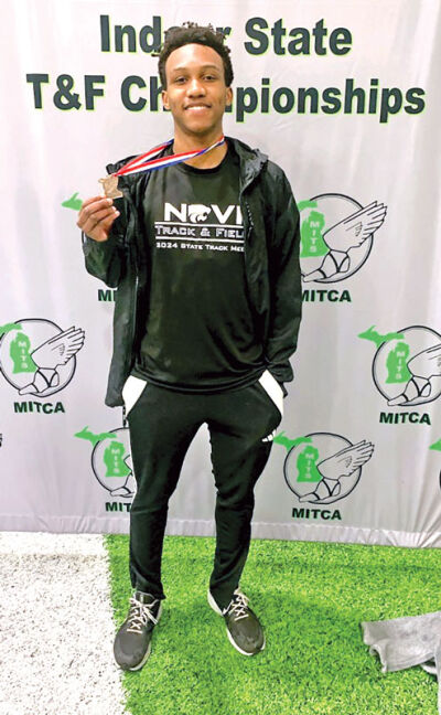  Drelen Lillard shows a medal he won for indoor high jumping during the Michigan Interscholastic Track Coaches Association Indoor State Track and Field Championships at Saginaw Valley State University in 2025. 